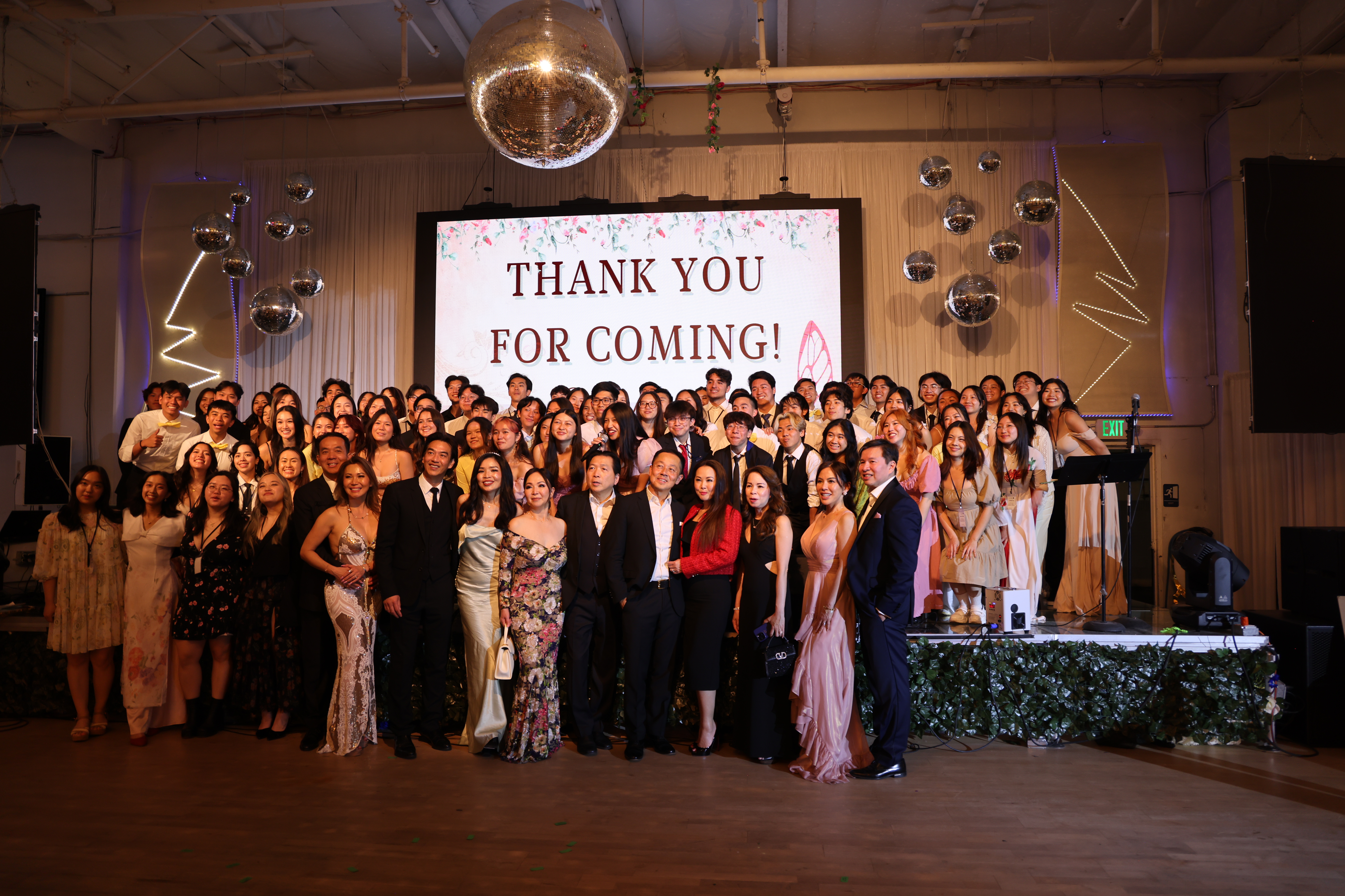 Large group photo under a thank you screen at MEMO's 2024 gala